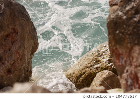 Detail shot of mediterranean rocks with turquoise sea Detail shot of mediterranean rocks with turquoise sea 104778617
