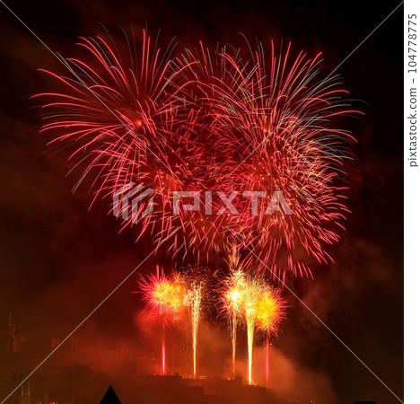Fireworks over Edinburgh Castle with view of the city. Finale of Edinburgh International Festival in United Kingdom. Fireworks over Edinburgh Castle with view of the city. Finale of Edinburgh International Festival in United Kingdom. 104778775