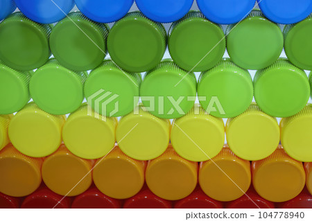 Multi-colors background of plastic drinking water caps. 104778940