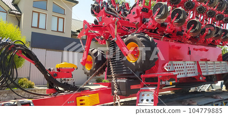 The colorful red seeder on the ground 104779885