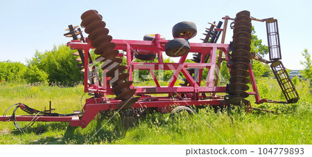 Large disc plough, towing for tractors to plow fields Large disc plough, towing for tractors to plow fields 104779893