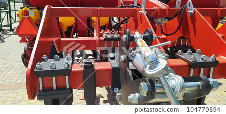 The colorful red seeder on the ground The colorful red seeder on the ground 104779894