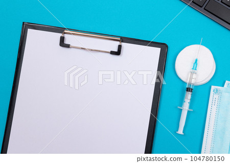 Vaccination or Revaccination Concept - A Medical Syringe on Blue Table 104780150