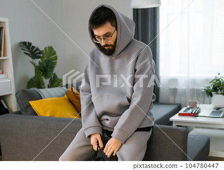 Sad man pondering about his life after a relationship breakup or bipolar disorder - depression asthenia , mental problem and anxiety disorder concept Sad man pondering about his life after a relationship breakup or bipolar disorder - depression asthenia , mental problem and anxiety disorder concept 104780447