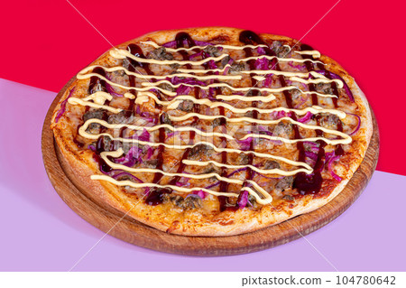 Pizza with bacon cheese and herbs on a wooden plate with cheese and cherry tomatoes. On a colored background. Pizza with bacon cheese and herbs on a wooden plate with cheese and cherry tomatoes. On a colored background. 104780642