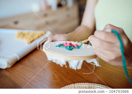 Punch needle. Asian Woman making handmade Hobby knitting in studio workshop. designer workplace Handmade craft project DIY embroidery concept. Punch needle. Asian Woman making handmade Hobby knitting in studio workshop. designer workplace Handmade craft project DIY embroidery concept. 104781666