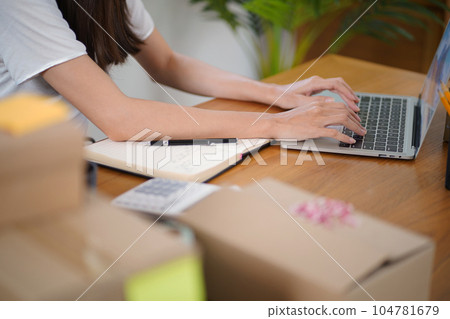 Business From Home Asian woman preparing package delivery box Shipping for shopping online. young start up small business owner at home online order Business From Home Asian woman preparing package delivery box Shipping for shopping online. young start up small business owner at home online order 104781679