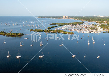 Aerial view of boats moored off Dinner Key Marina in Coconut Grove, Florida. Aerial view of boats moored off Dinner Key Marina in Coconut Grove, Florida. 104782026