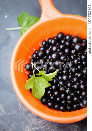 Blackberry in an orange sieve 104782101