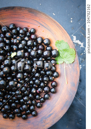 black currants in a large wooden bowl black currants in a large wooden bowl 104782162