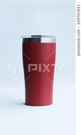 Red stainless steel tumbler and mug vacuum insulated double wall travel cup with lid isolated on white. Red stainless steel tumbler and mug vacuum insulated double wall travel cup with lid isolated on white. 104783841