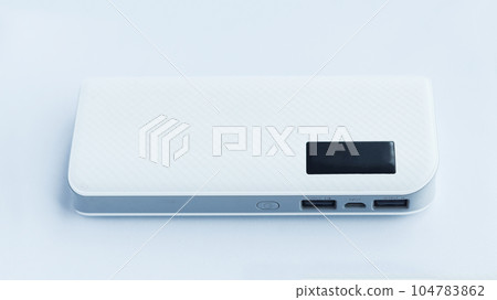 A white flat power bank isolated on white background with two usb output and one input socket electrical source. 104783862