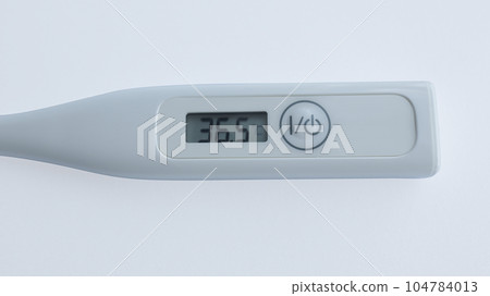 Digital thermometer isolated on white used to measure body temperature. Digital thermometer isolated on white used to measure body temperature. 104784013