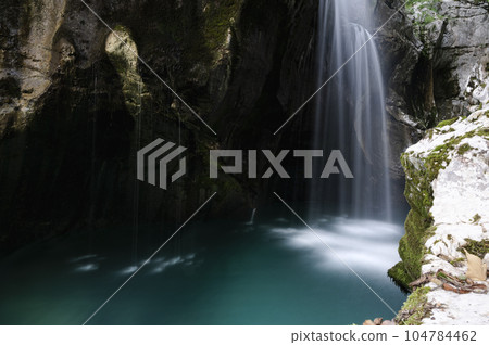 Beautiful blurred image of Soca river waterfall 104784462