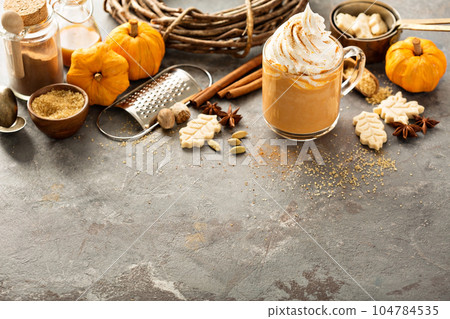 Pumpkin spice latte in a glass mug 104784535
