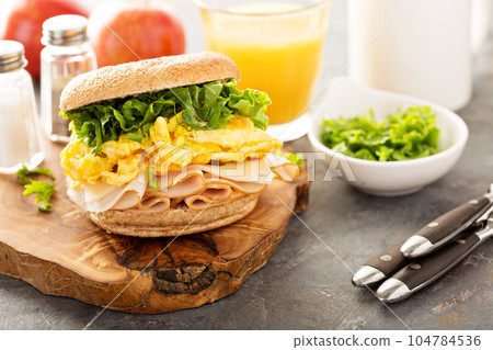 Breakfast bagel with scrambled eggs and turkey 104784536