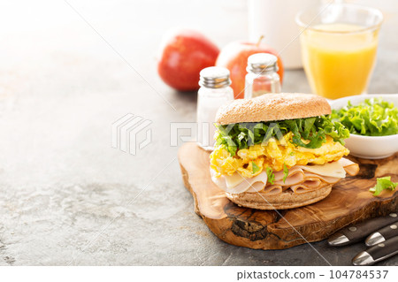 Breakfast bagel with scrambled eggs and turkey 104784537
