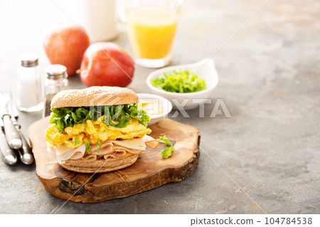 Breakfast bagel with scrambled eggs and turkey 104784538