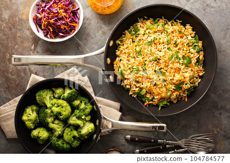 Fried rice with vegetables and steamed broccoli Fried rice with vegetables and steamed broccoli 104784577