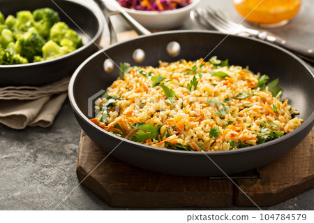 Fried rice with vegetables and steamed broccoli 104784579