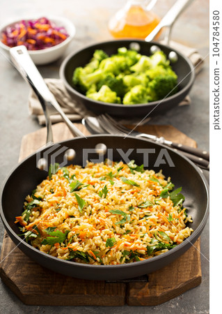 Fried rice with vegetables and steamed broccoli 104784580