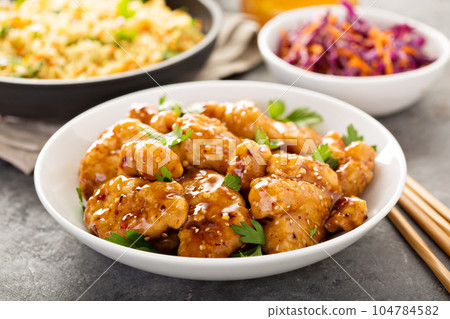 Spicy sweet and sour chicken with rice and cabbage 104784582