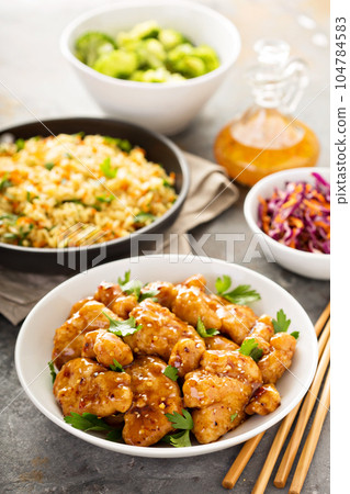 Spicy sweet and sour chicken with rice and cabbage 104784583