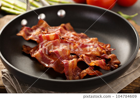 Cooked bacon on a skillet Cooked bacon on a skillet 104784609