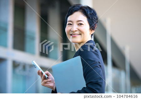 middle business woman with smartphone in office middle business woman with smartphone in office 104784616