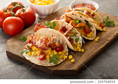 Breakfast tacos with scrambled eggs and bacon 104784654