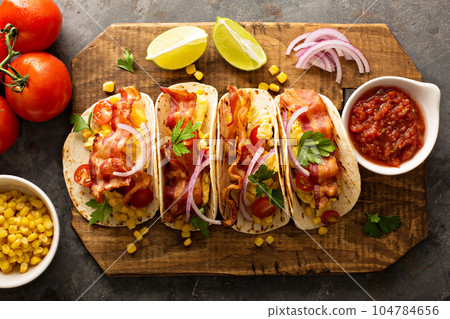 Breakfast tacos with scrambled eggs and bacon 104784656
