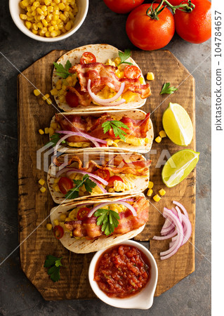 Breakfast tacos with scrambled eggs and bacon 104784657