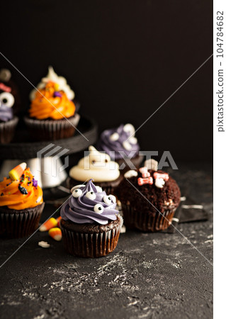 Festive Halloween cupcakes and treats Festive Halloween cupcakes and treats 104784682