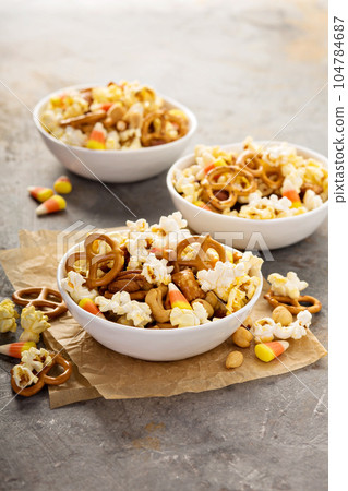 Homemade Halloween trail mix with popcorn, pretzels and nuts Homemade Halloween trail mix with popcorn, pretzels and nuts 104784687