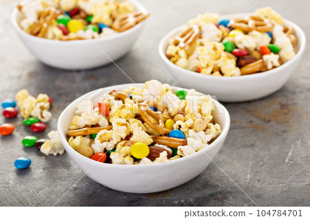 Homemade trail mix with chocolate candy, popcorn, pretzels and nuts Homemade trail mix with chocolate candy, popcorn, pretzels and nuts 104784701