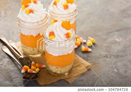 Halloween dessert in a jar layered candy corn parfait 104784728