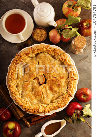 Apple pie decorated with fall leaves 104784791