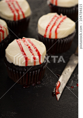 Spooky Halloween themed cupcakes with fake blood 104784815