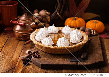 Pumpkin pie with whipped cream 104784836