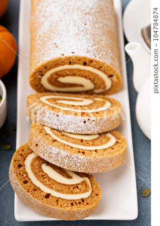 Pumpkin roll with cream cheese frosting 104784874