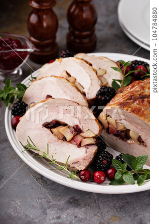 Roasted pork loin stuffed with apple and cranberry Roasted pork loin stuffed with apple and cranberry 104784880