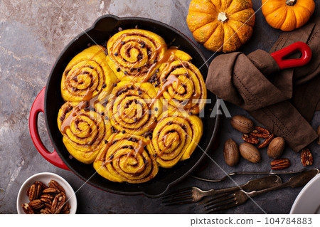 Pumpkin cinnamon rolls in a cast iron skillet Pumpkin cinnamon rolls in a cast iron skillet 104784883