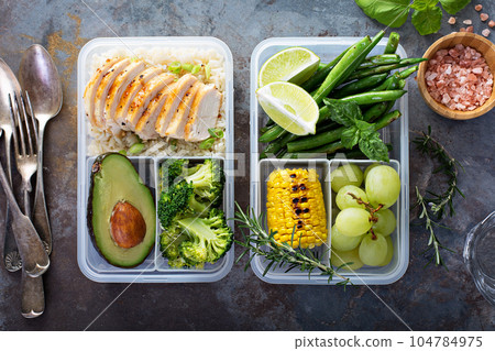 Healthy green meal prep containers with rice and vegetables 104784975