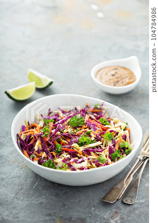 Asian cole slaw with peanut butter dressing Asian cole slaw with peanut butter dressing 104784986