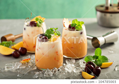 Summer cherry and peach coconut milk cocktail 104785003