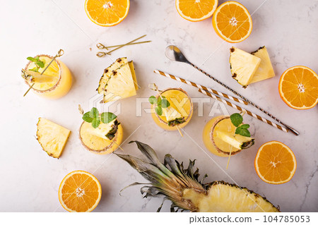Orange and pineapple cocktails Orange and pineapple cocktails 104785053