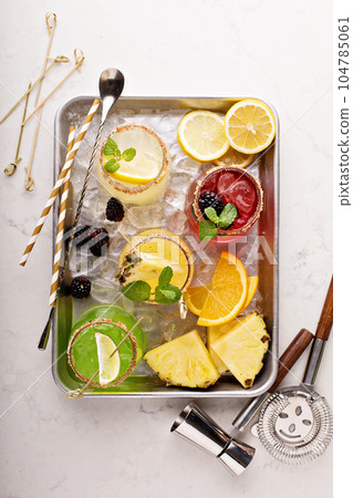 Variety of margarita cocktails on a tray Variety of margarita cocktails on a tray 104785061