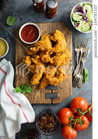 Breaded chicken tenders with ketchup 104785107
