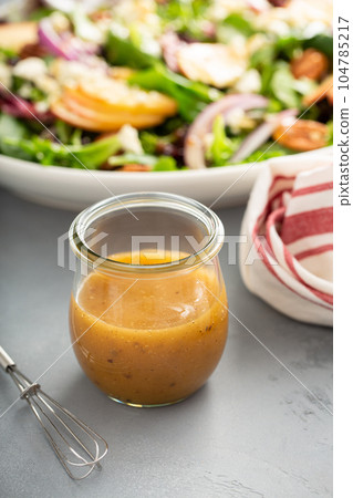Apple cider vinaigrette salad dressing in a mason jar Apple cider vinaigrette salad dressing in a mason jar 104785217