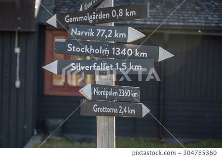 signpost Abisko Sweden Arctic Circle indicates distance and direction to various towns like Northpole and Stockholm 104785360